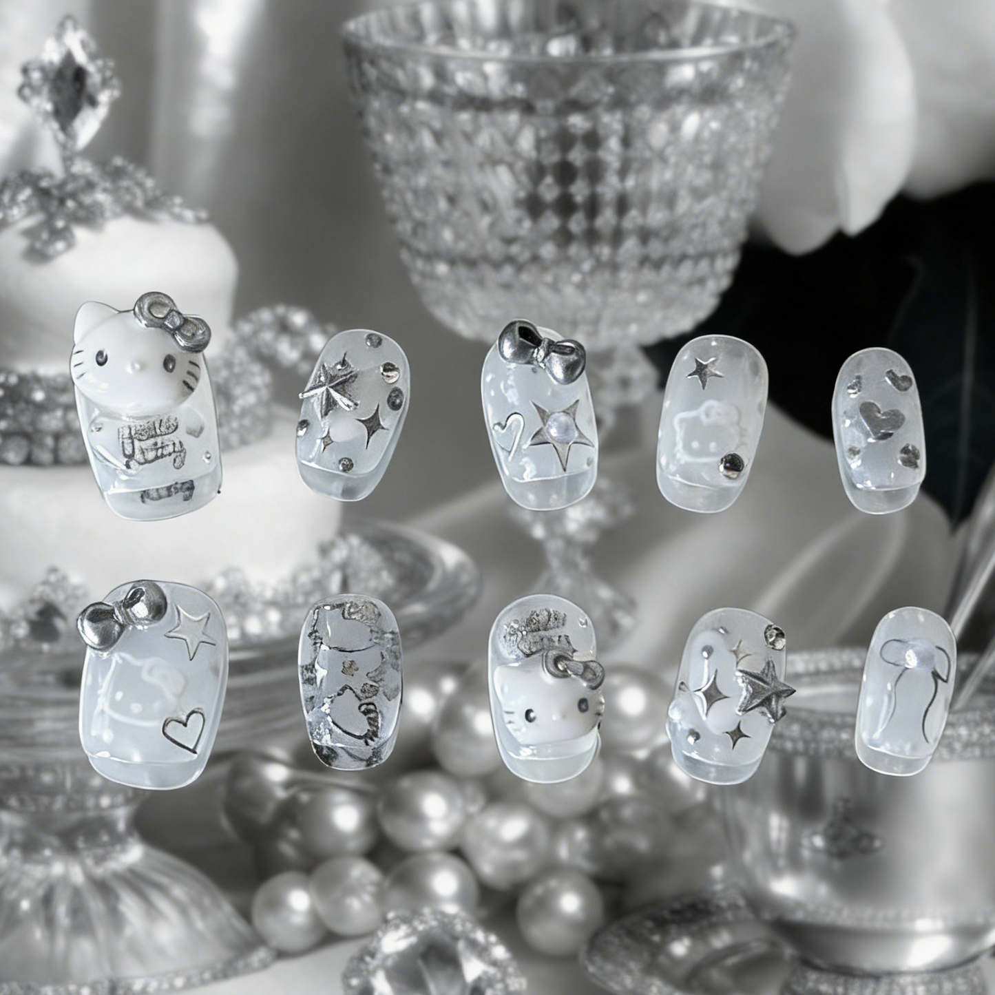 Silver Kitty press-on nails by MYOB Nails featuring silver chrome accents and iconic kitten silhouettes on a sheer white base.