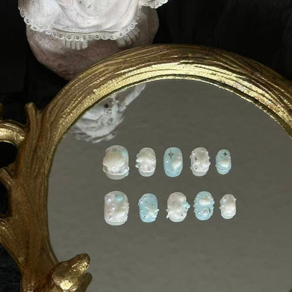 Front view of Siren's Treasure nails showing the dreamy jelly blue base and intricate oceanic charms.