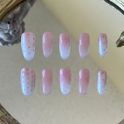 Front view of Softglow handmade nails showcasing the shimmering aurora finish and pink polka dot accents.