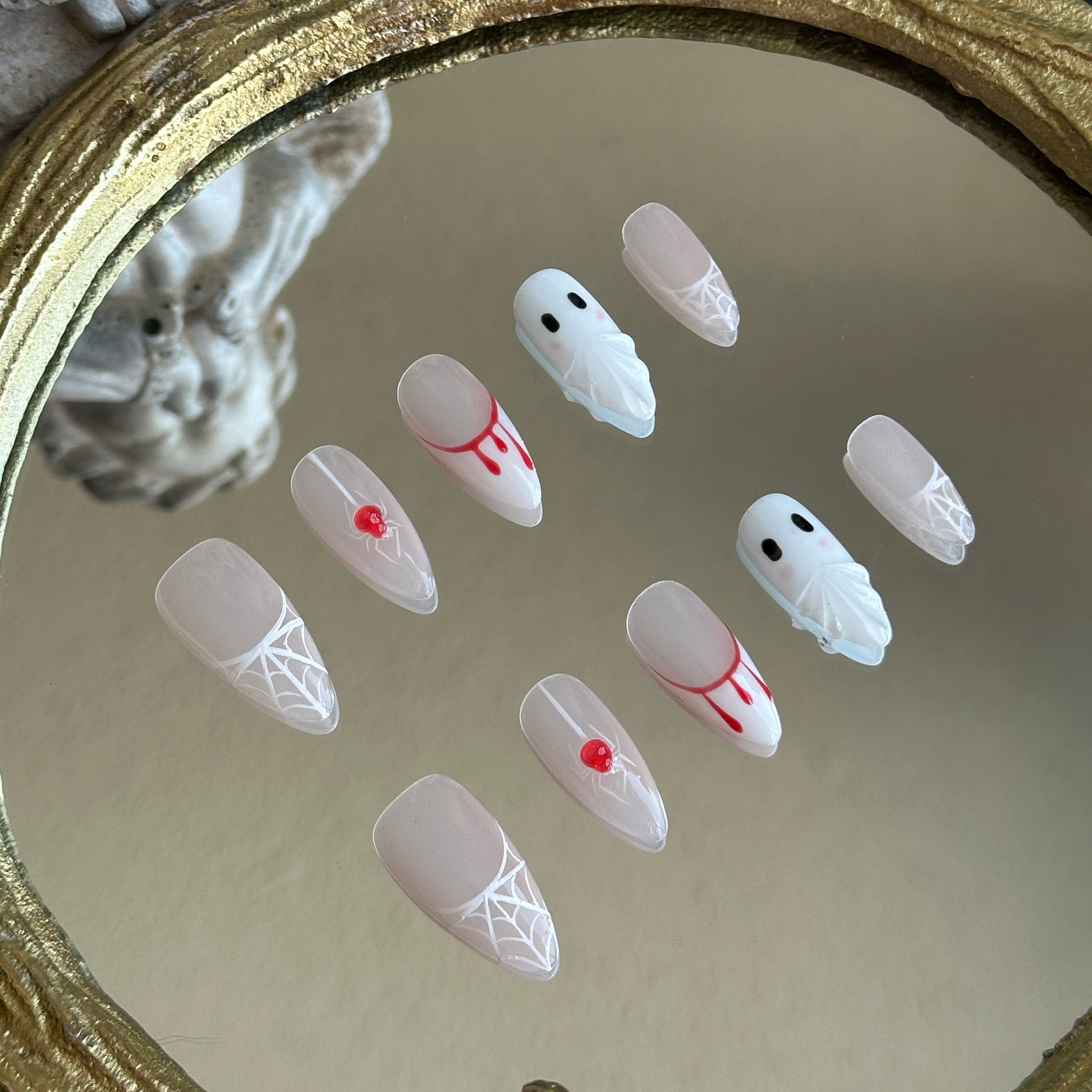 Left side detail of MYOB Nails Spooky Webs set highlighting the realistic 3D crimson blood-drip and waterdrop effects.