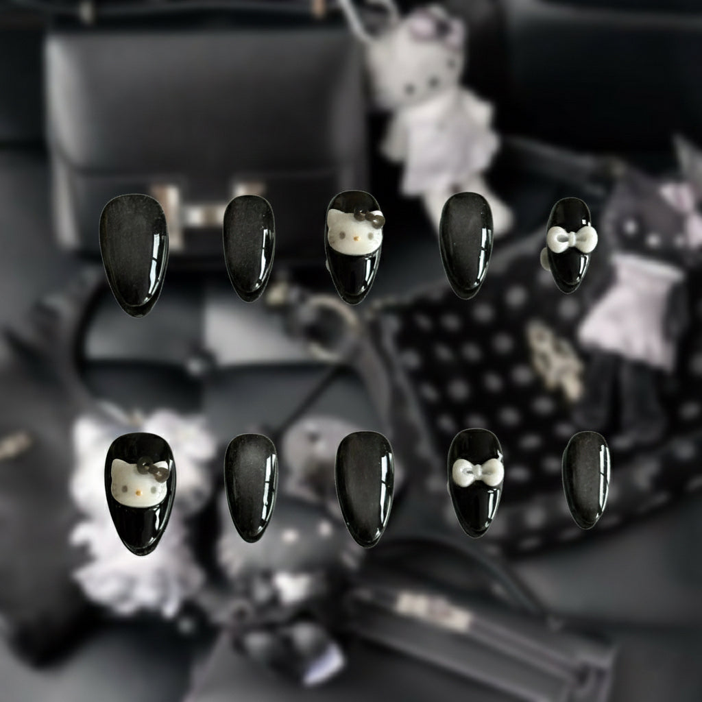 Close-up of the galaxy-like cat-eye shimmer and silver bow accents on the Stargazer nail set by MYOB Nails.