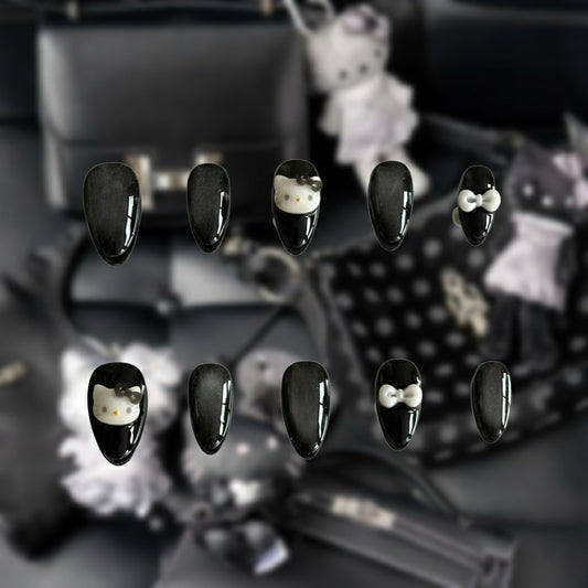 Close-up of the galaxy-like cat-eye shimmer and silver bow accents on the Stargazer nail set by MYOB Nails.