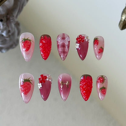 Front view of Strawberry Picnic handmade nails showing hand-painted strawberries and classic red-and-white checkers.