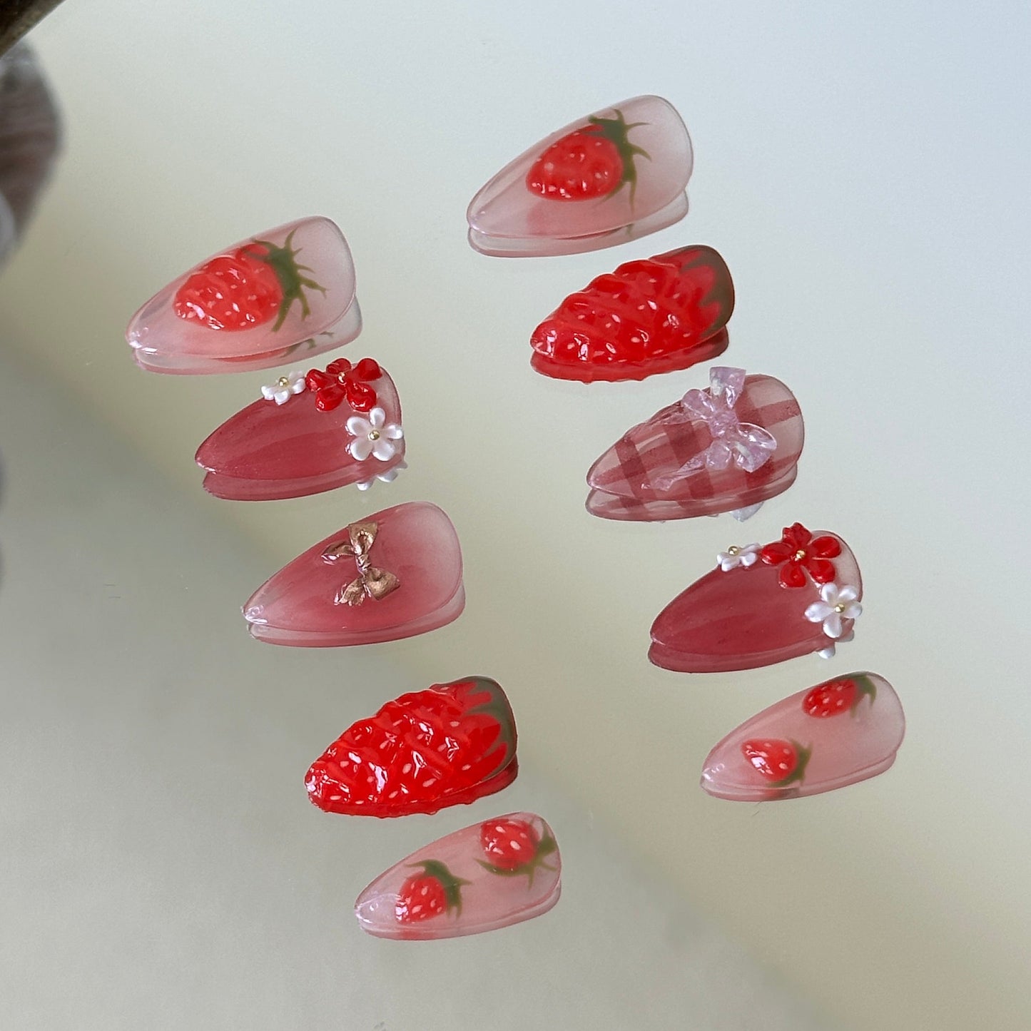 Right side view showcasing delicate white lace lines and tiny red bow accents on a sheer nude base.