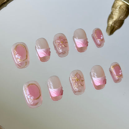 Close-up of the 3D transparent sculpted flowers with intricate gold chrome petal outlines by MYOB Nails.