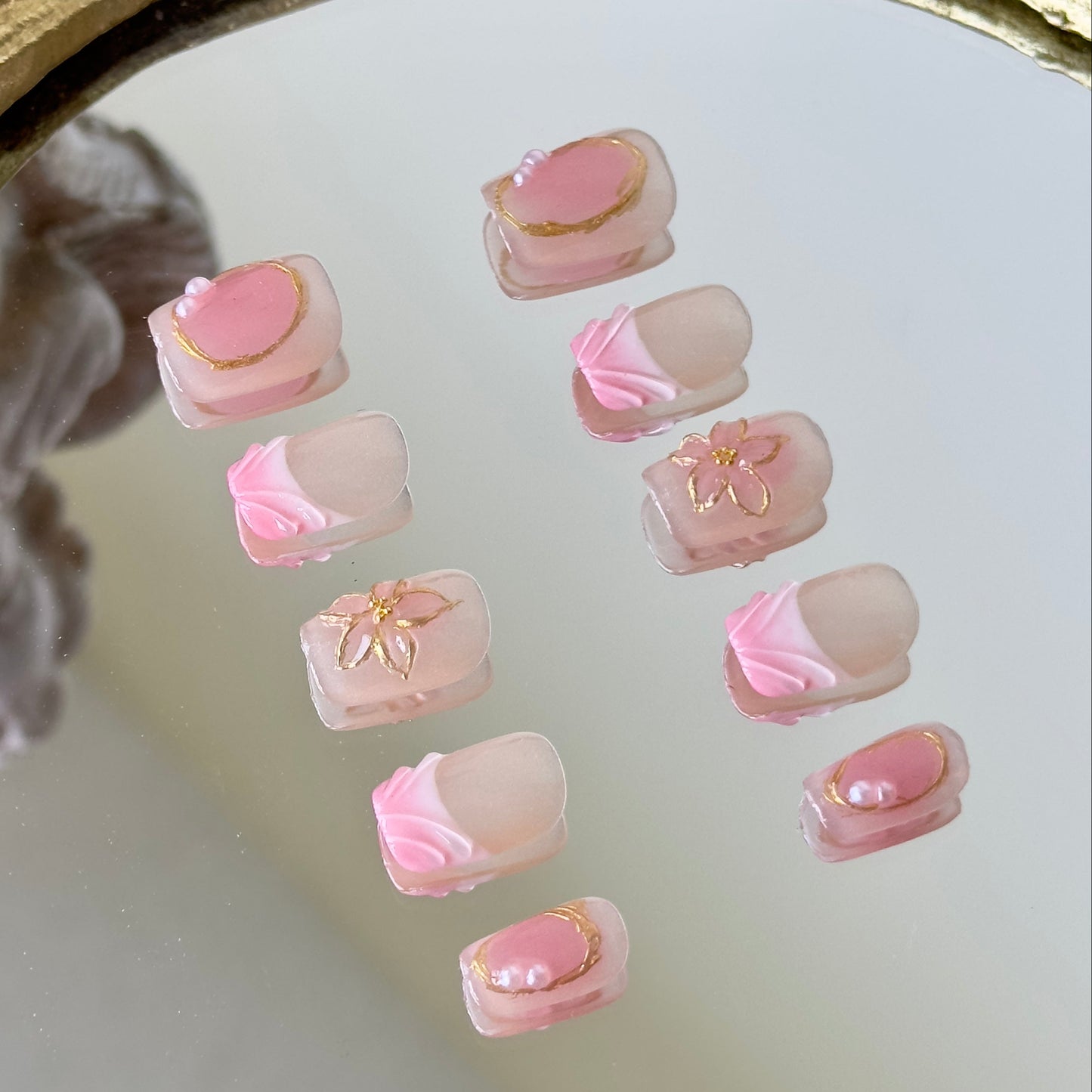 Side view highlighting the irregular gold chrome borders, pearl accents, and 3D water droplet lines.