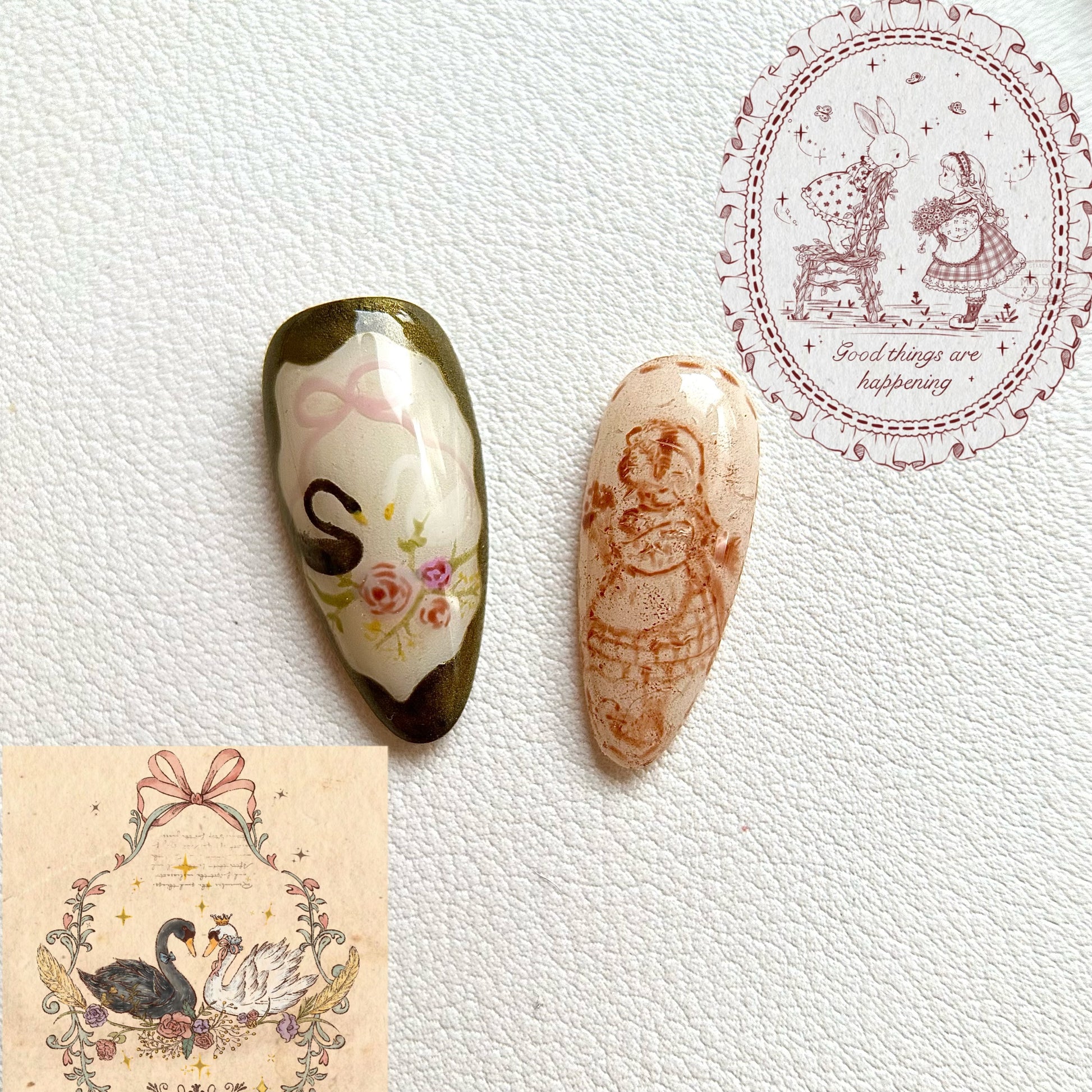 Close-up of MYOB Nails' handcrafted artistry, featuring a delicate hand-painted swan with a pink bow and a vintage-style portrait of a girl, showcasing intricate linework on a shimmering base.