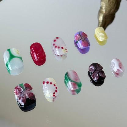 Close-up detail of the vibrant red 3D flower and playful polka dot patterns by MYOB Nails.