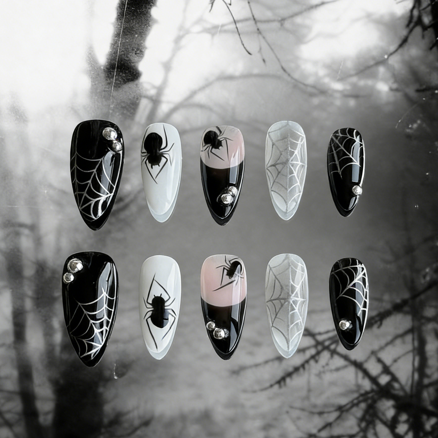 MYOB Nails' Web of Shadows press-on nails featuring gothic spider web patterns, spiders, and a moody foggy background.