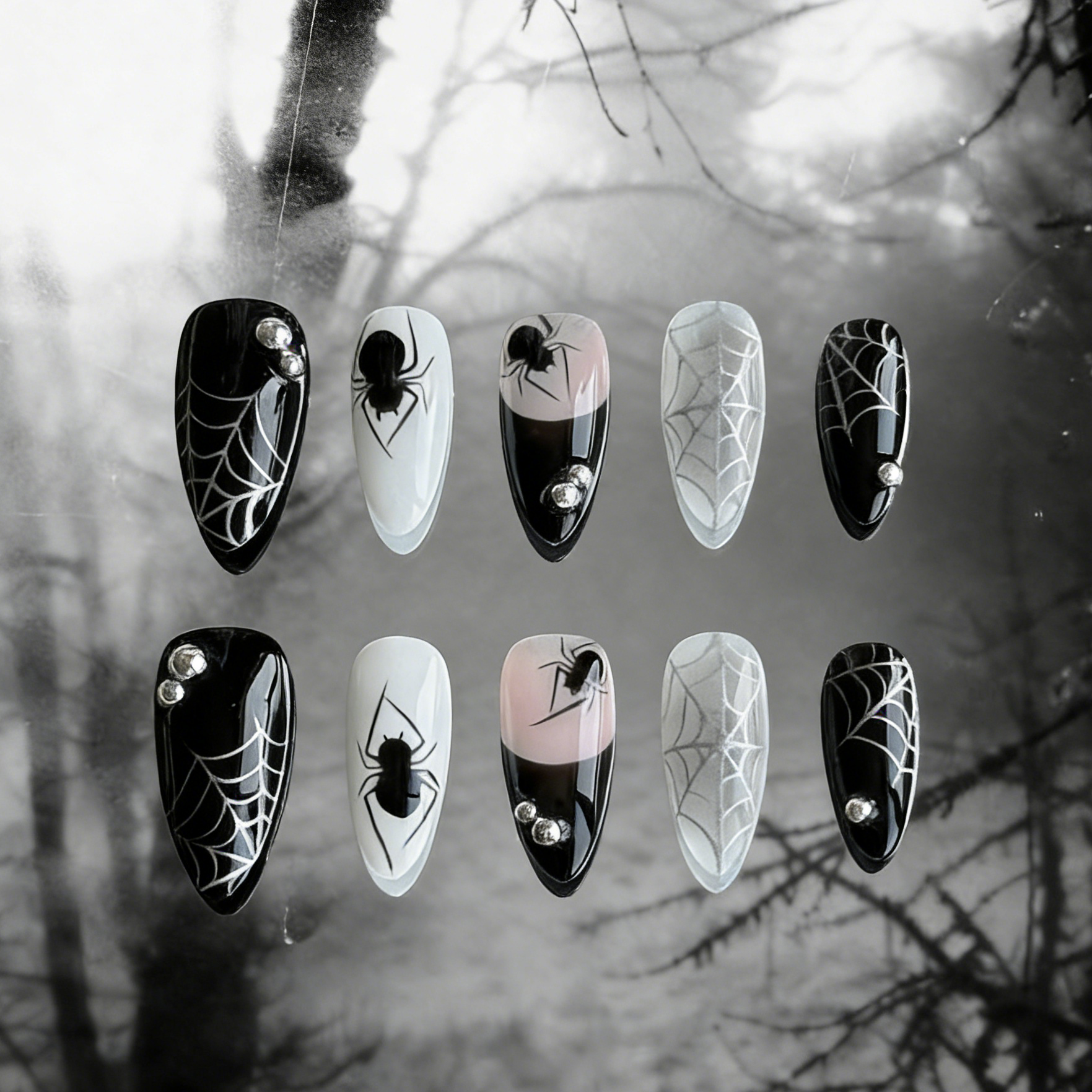 MYOB Nails' Web of Shadows press-on nails featuring gothic spider web patterns, spiders, and a moody foggy background.