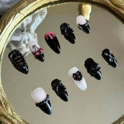 Left side detail of MYOB Nails Witches Don't Age set highlighting the realistic 3D cherry charms and hand-painted gothic lettering.