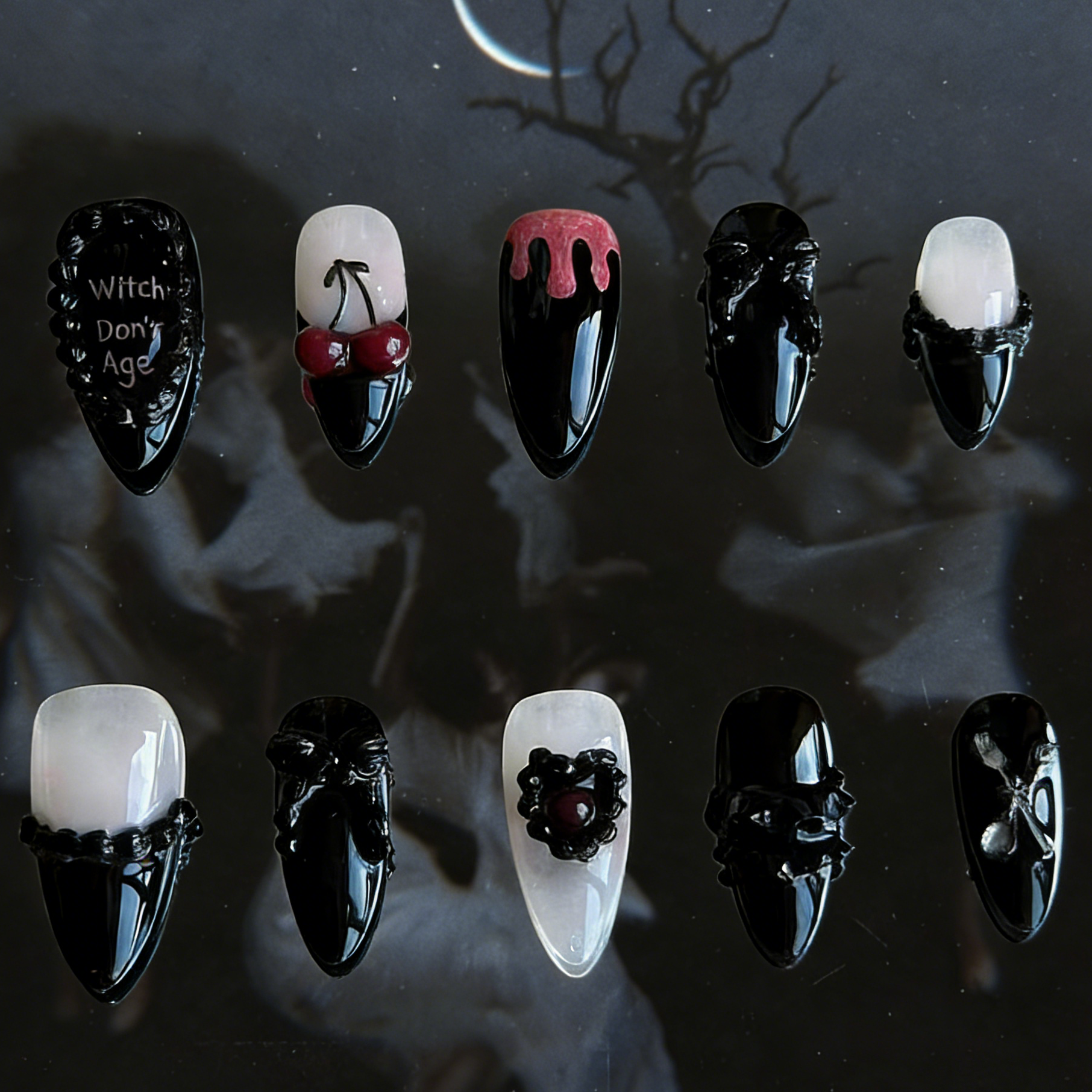 Witches Don't Age press-on nails by MYOB Nails featuring black and white gothic design with heart embellishments and drip patterns.