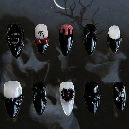 Witches Don't Age press-on nails by MYOB Nails featuring black and white gothic design with heart embellishments and drip patterns.