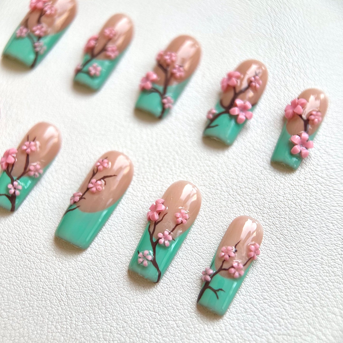 Side view highlighting the artistic hand-painted brown branches and the glossy top coat of the set.